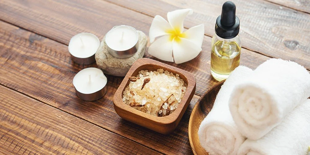 Spa oils, towels and frangipani flowers